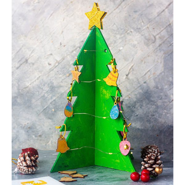 Handcrafted Christmas tree adorned with festive ornaments, lights, and a personalized touch, adding warmth and charm to the holiday season.